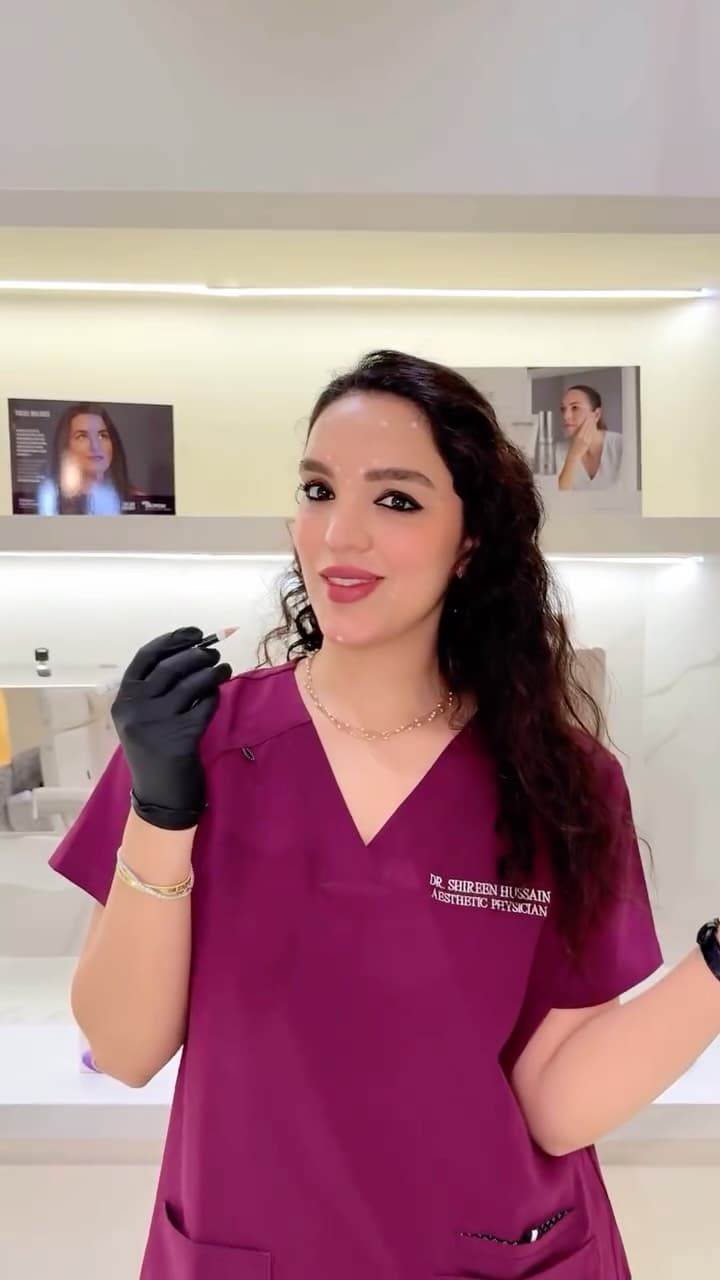 Dr. Shireen Hussain in clinic scrubs and gloves, ready for a treatment